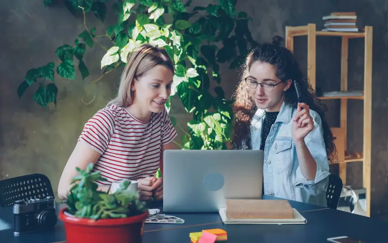 Two students working on laptops