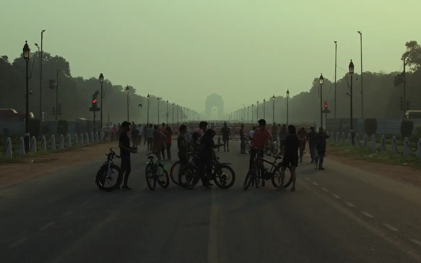 Rajpath in New Delhi at dusk, with cyclists on the road