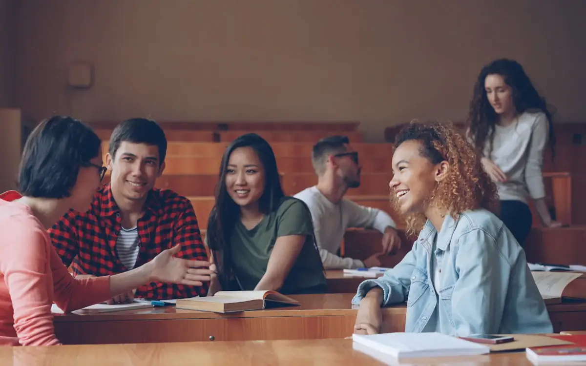 Students discussing around a table in a lecture room