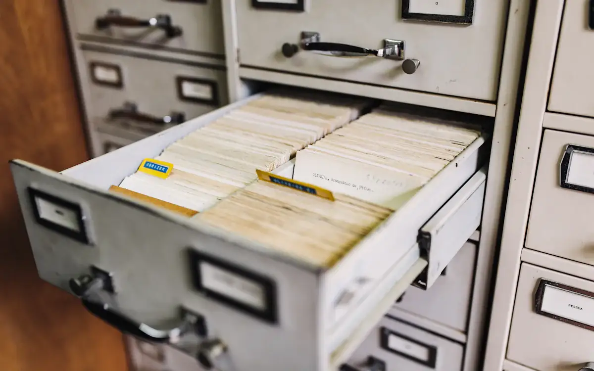 An open filing cabinet drawer full of records